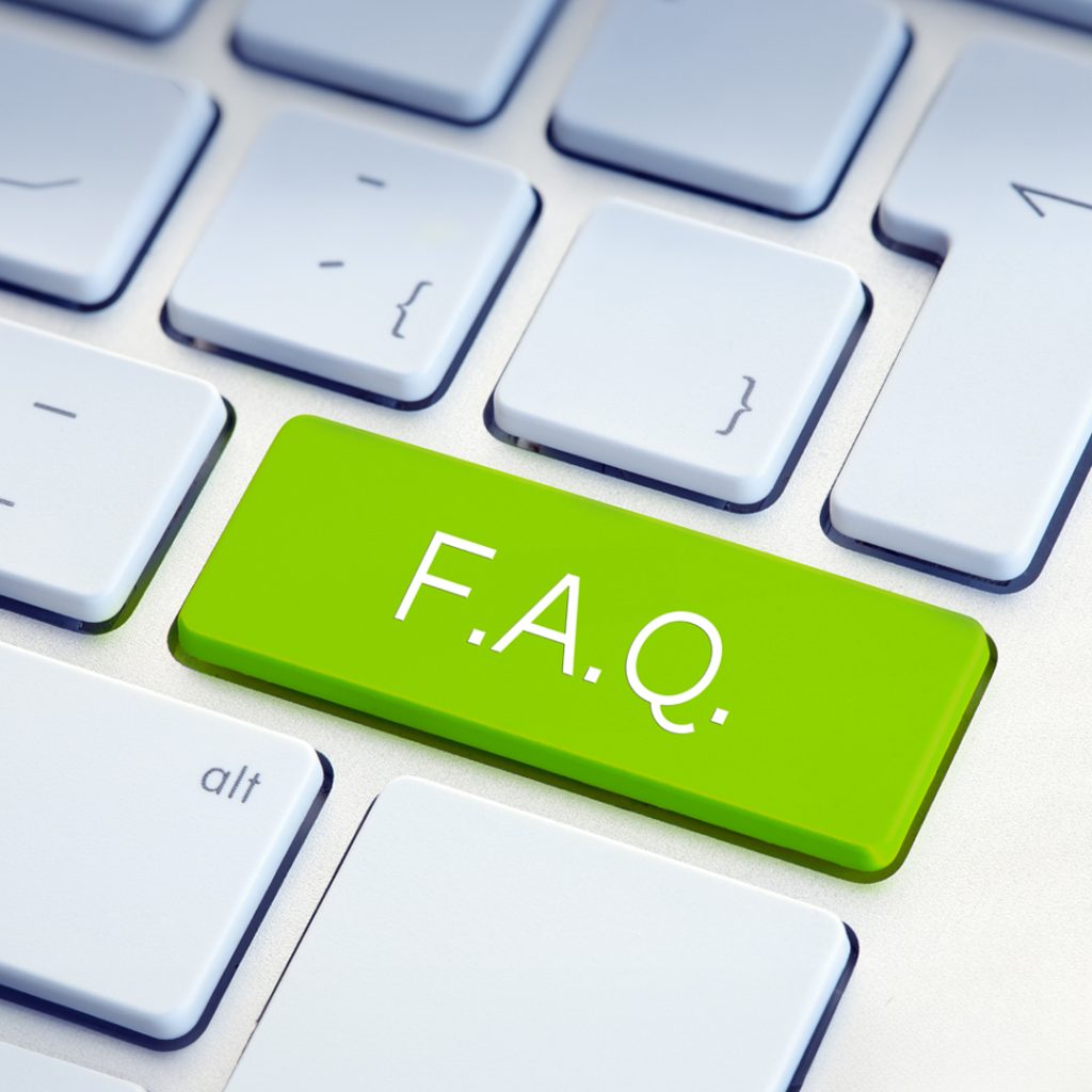 Close-up of a keyboard with a green 'FAQ' key, symbolizing information and support at Green Mortgage Lawyers.
