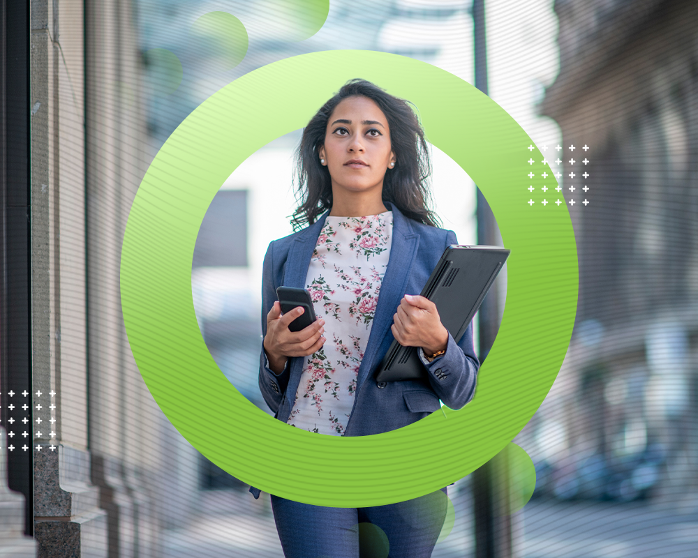 Professional woman walking confidently with a laptop and phone, representing Green Mortgage Lawyers' commitment to innovation.